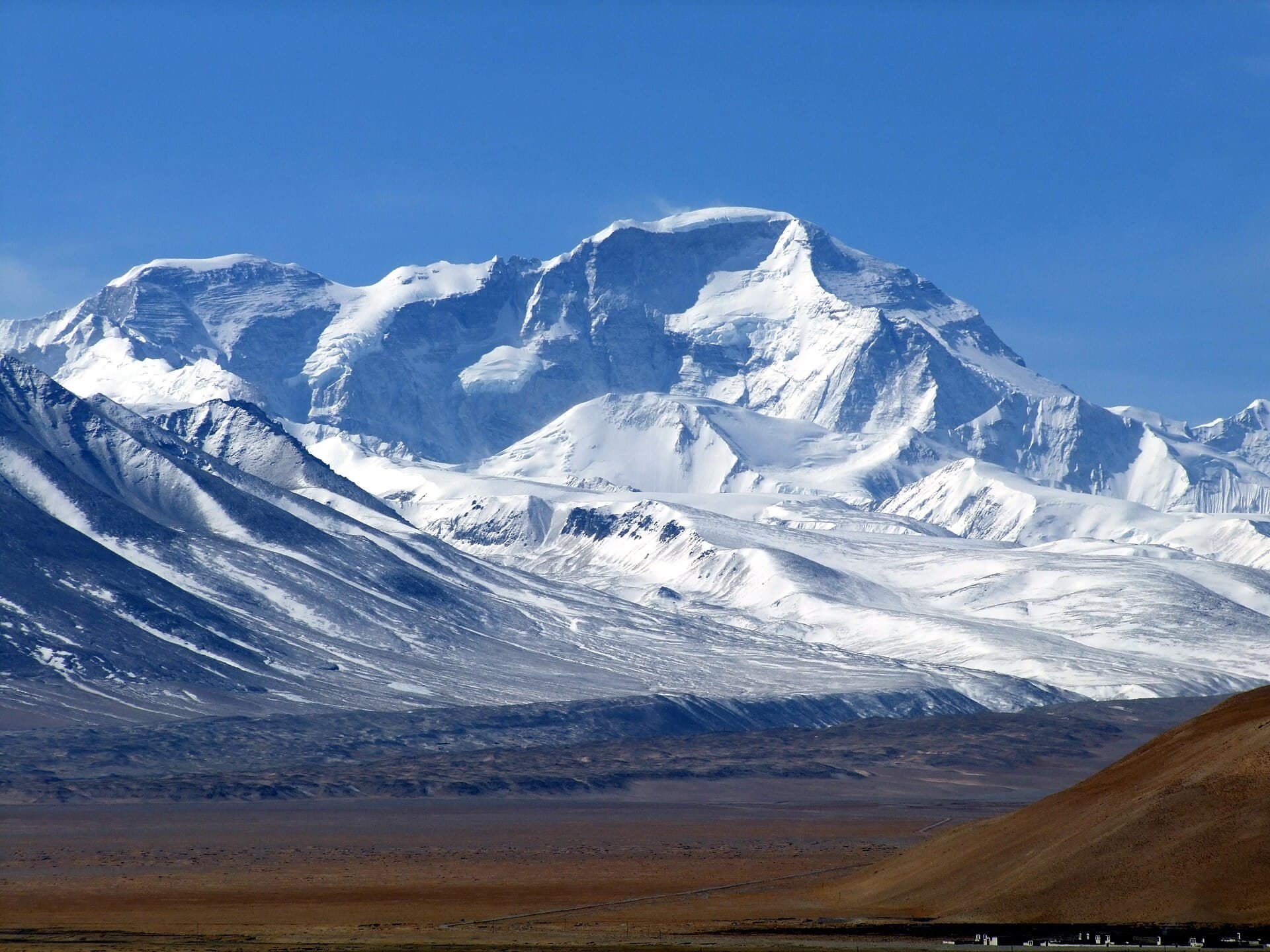 The North Face of Cho Oyu (8201m), the sixth highest mountain of world, from the village of Tingri in Tibet. The 7916m peak on the left is the one the Nepalese government propose be named Tenzing Peak.